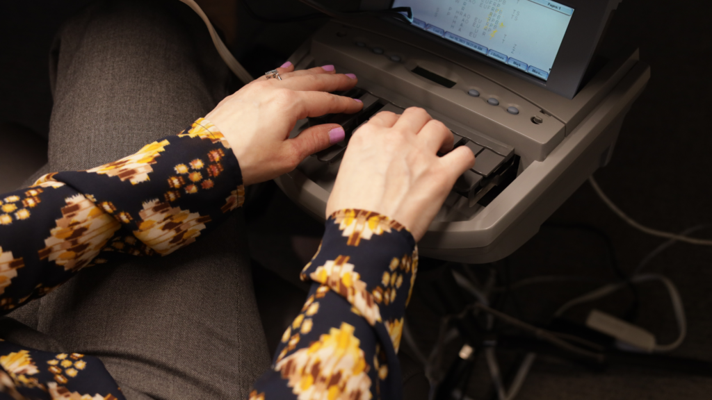 What Does a Court Reporter Do: Hands on a stenograph