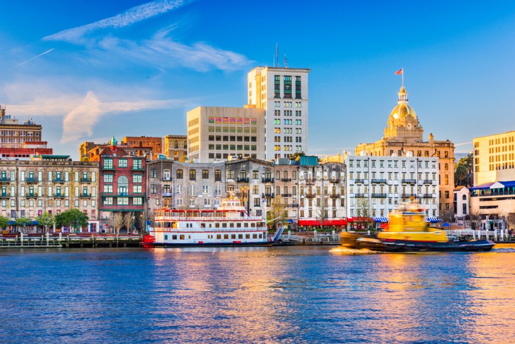 Photo of Savannah waterfront with buildings and boat.